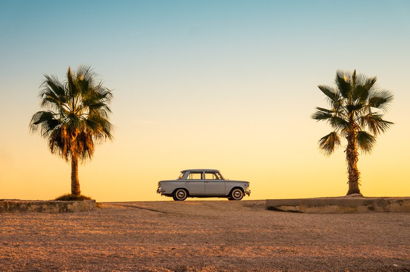 white and black car on brown sand during daytime