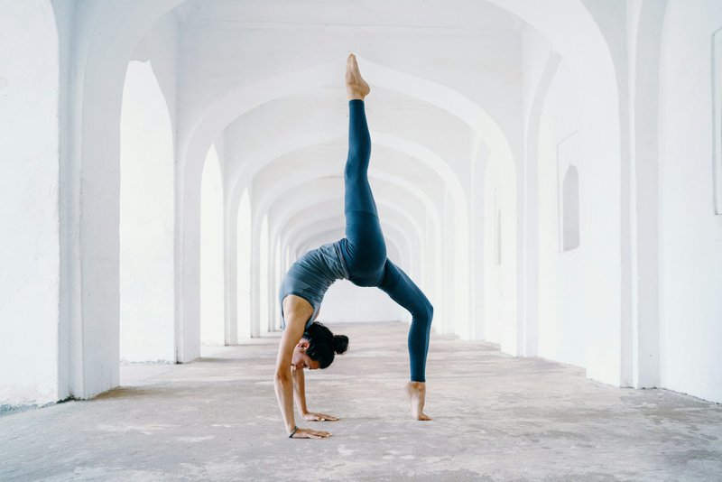 woman doing yoga in white temple