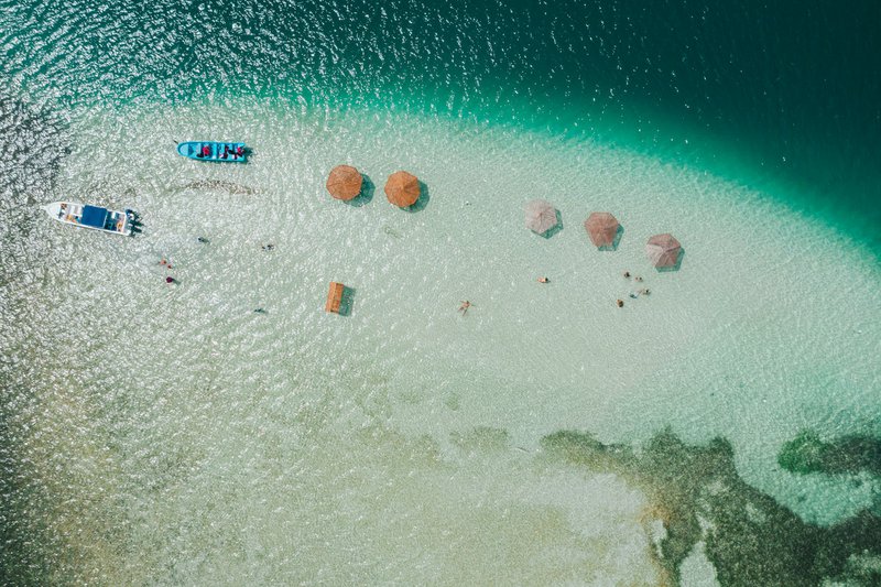 An aerial view of a sandy beach and ocean